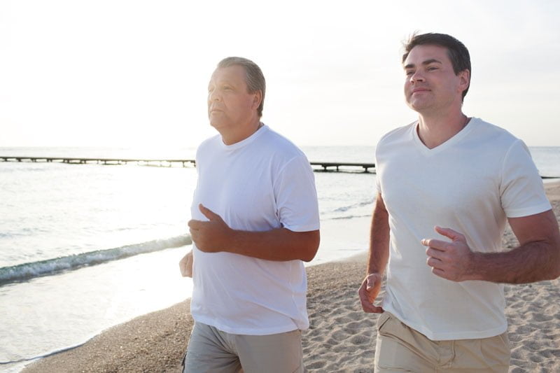 An image of two men running along the coast in bright sunlight, showcasing the improvement in lung health through Sentral IVs, allowing you to breathe easier
