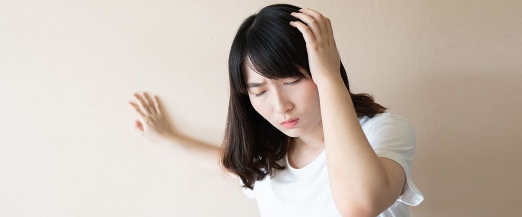 Young asian female suffering from dizziness because of anemia.