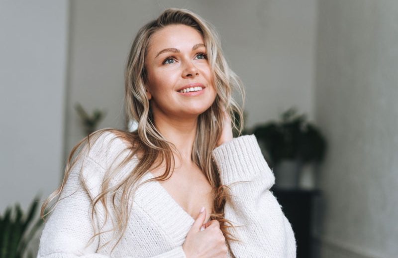 Blonde smiling woman 35 year plus clean fresh face, exemplifying the results of choosing Sentral IVs to 'Reclaim Your Youthful Glow