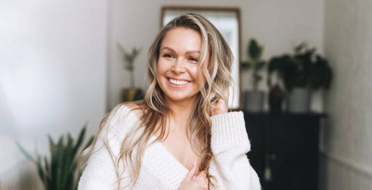 A radiant, smiling woman with rejuvenated skin and vibrant energy, embodying the promise to 'Reclaim Your Youthful Glow with Sentral IVs