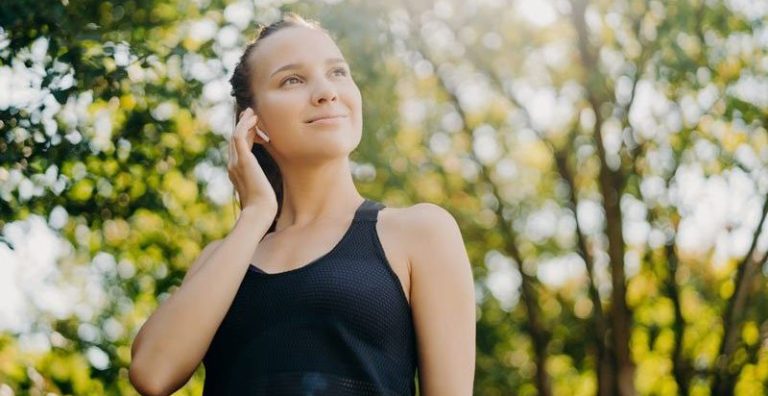 An image of a vibrant and joyful athletic woman gazes into the distance, embodying the benefits of Sentral IVs' Strong Defense IV Drip.